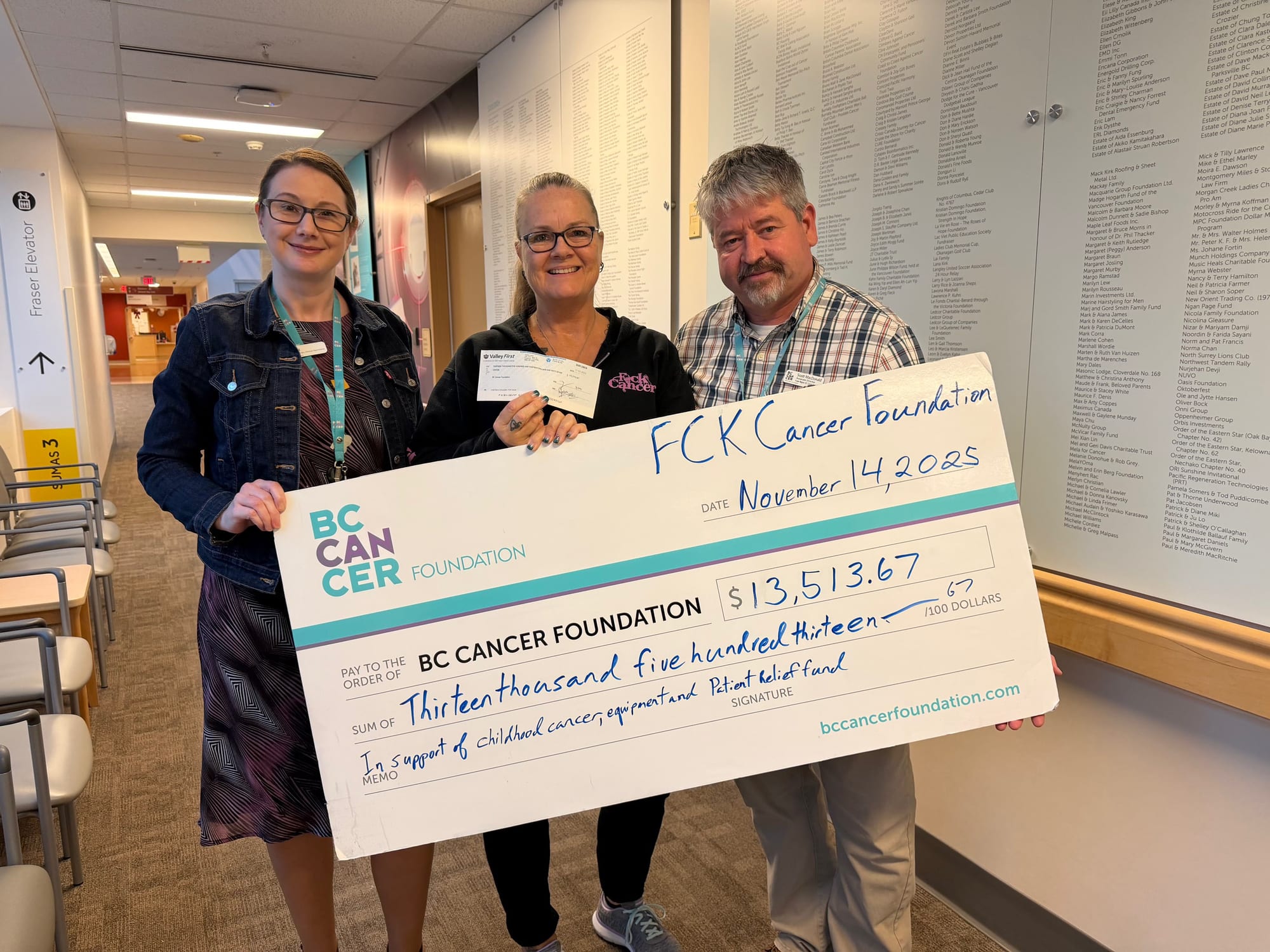 Three people holding a $13,513.67 cheque from the BC Cancer Foundation